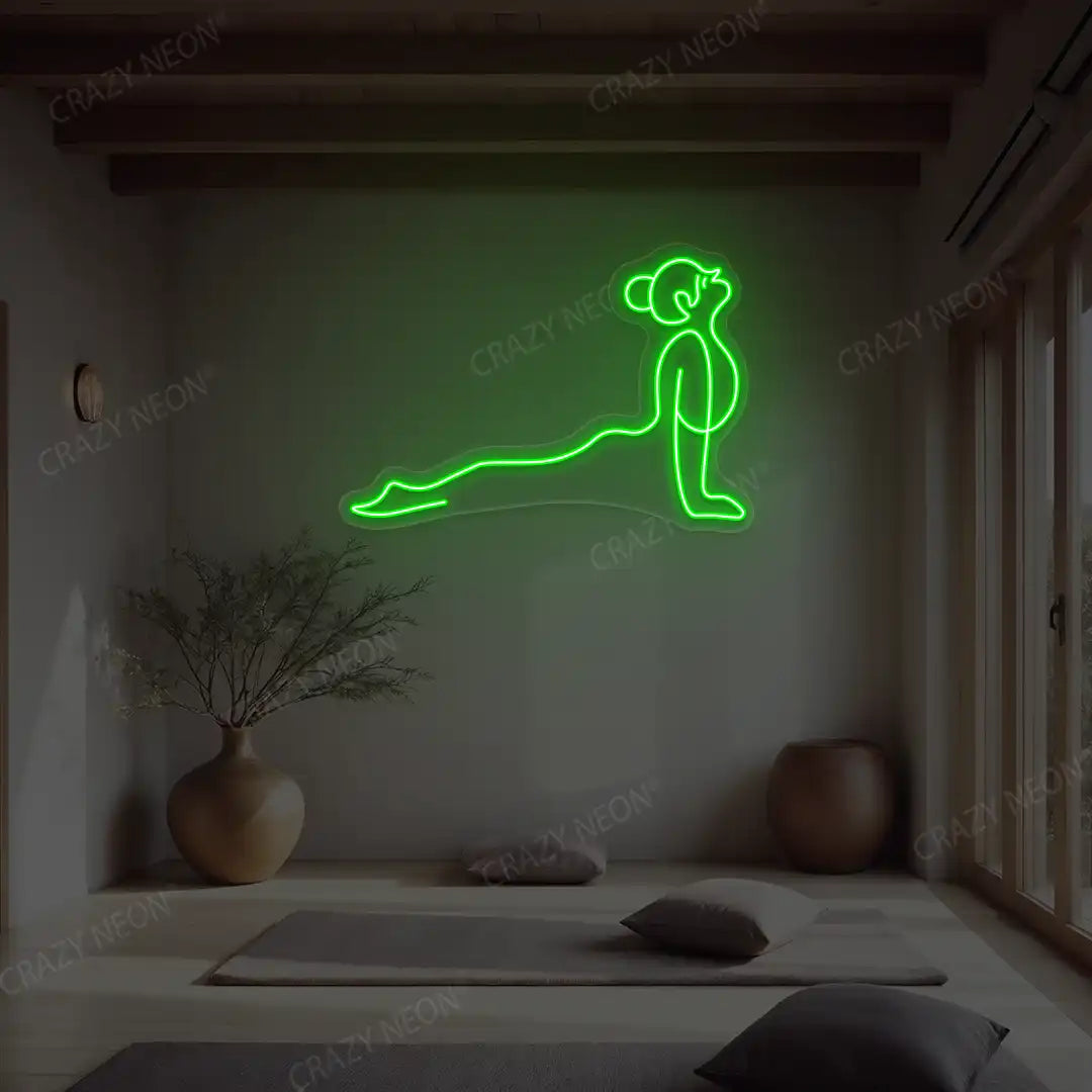 Urdhva Mukha Svanasana Yoga Neon Sign lighting up in green color in a yoga room