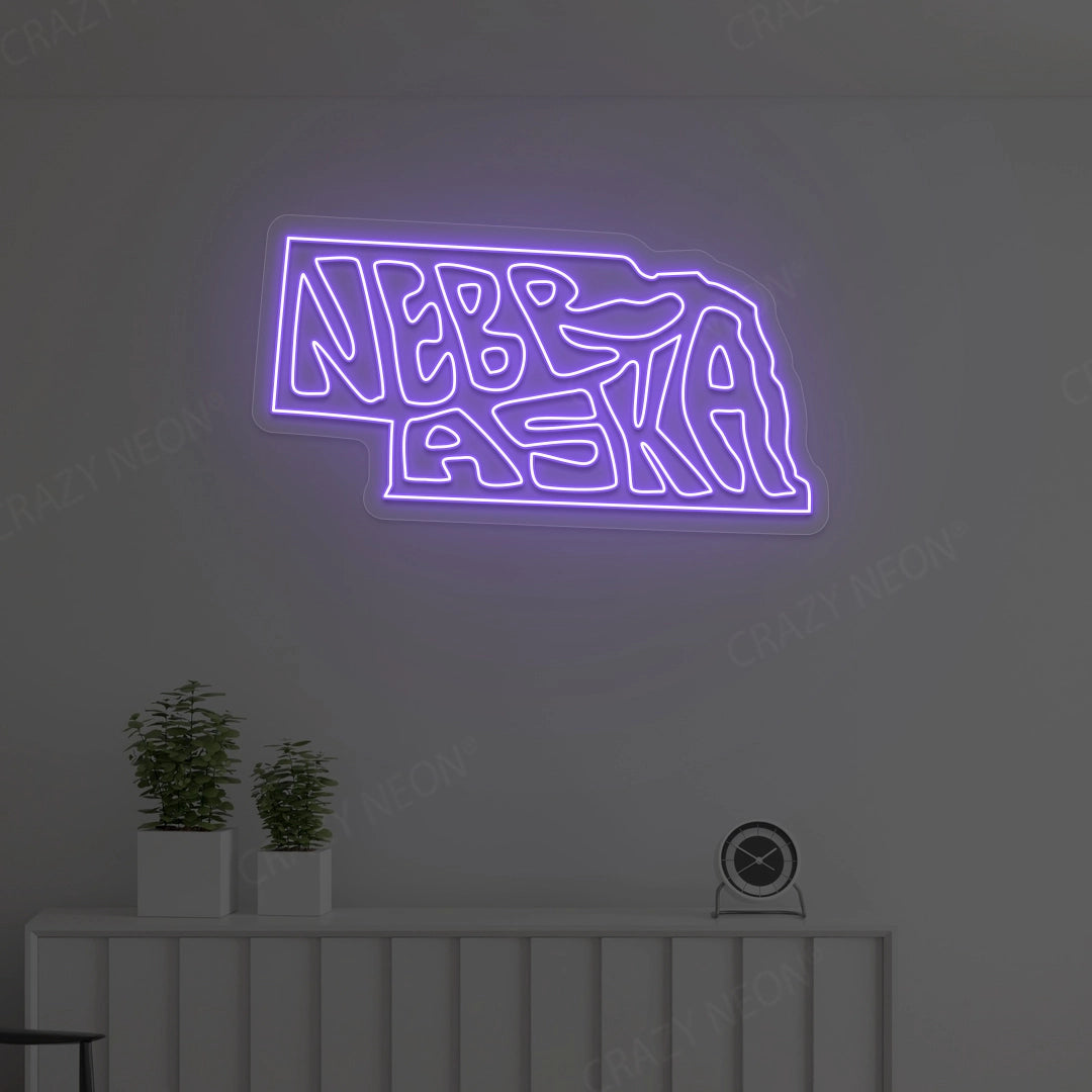 NEBRASKA Map Neon Sign lighting up in purple color in a room