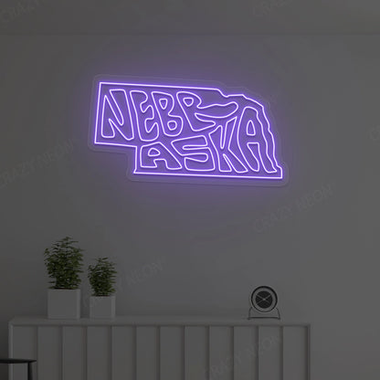 NEBRASKA Map Neon Sign lighting up in purple color in a room