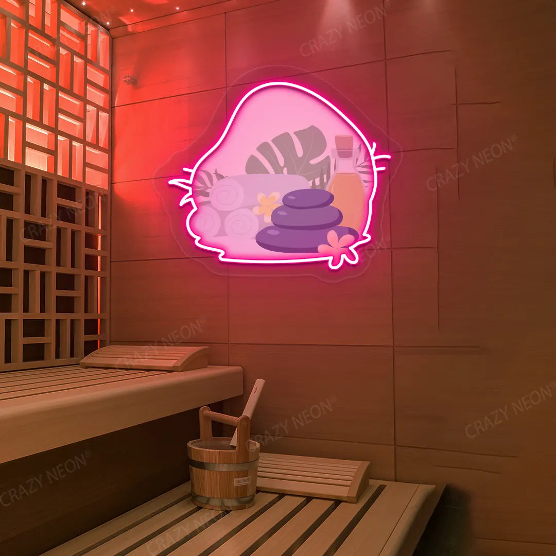 Spa Stones & Serenity Neon Artwork lighting up in pink color on a wooden wall