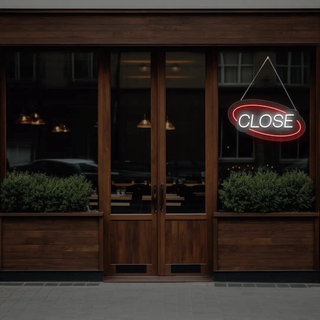 red semi oval close neon sign hanging on a window