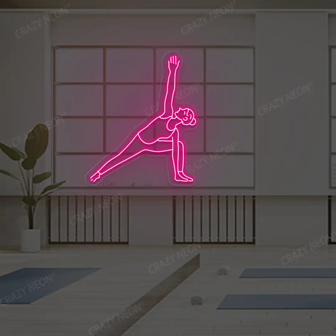 Utthita Parsvakonasana Yoga Neon Sign lighting up in pink color in a yoga room
