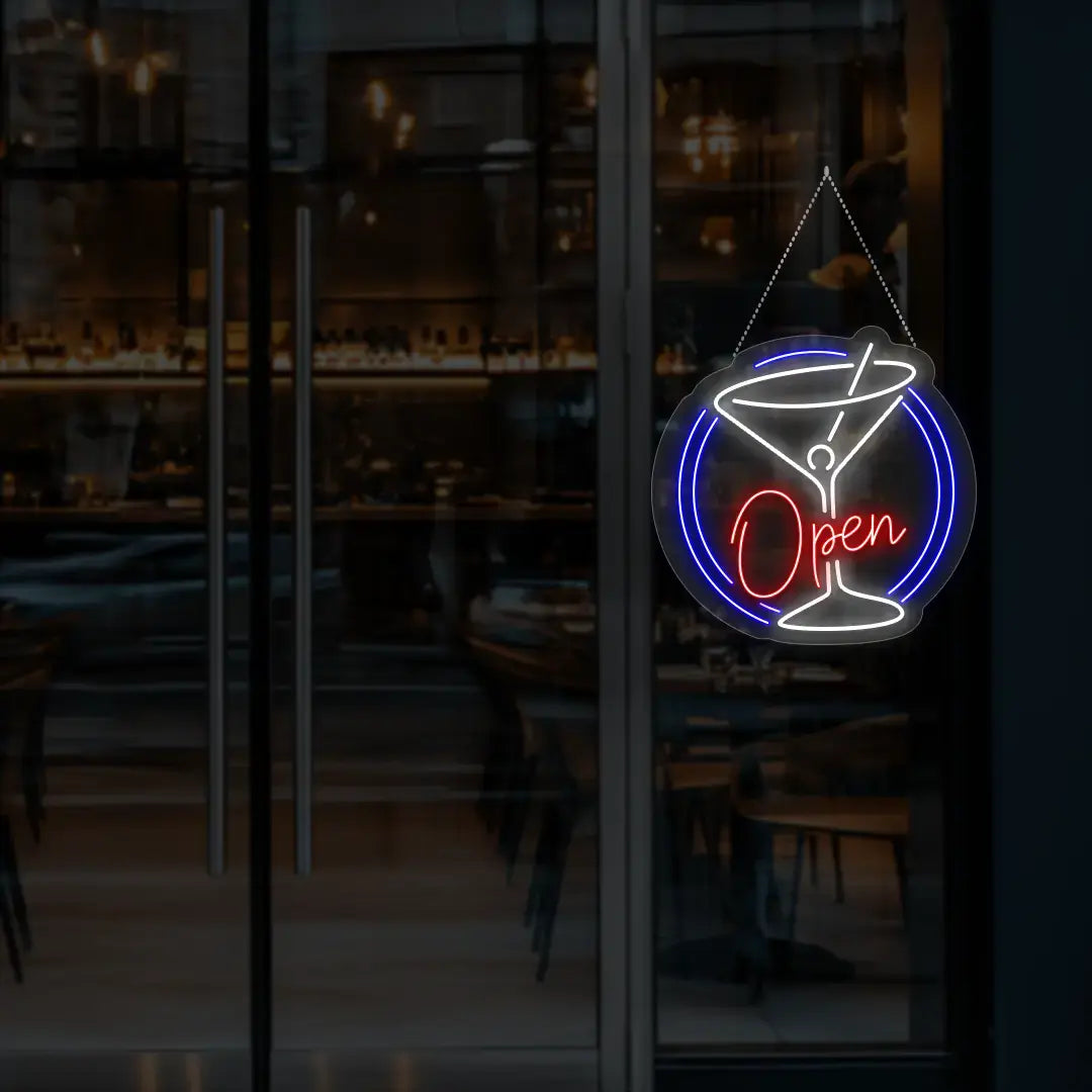 red cocktail open neon sign hanging on a window