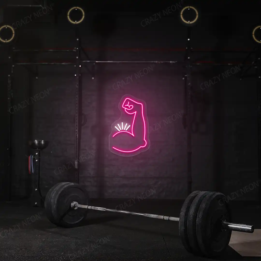 pink and white bicep pump neon sign mounted on a wall