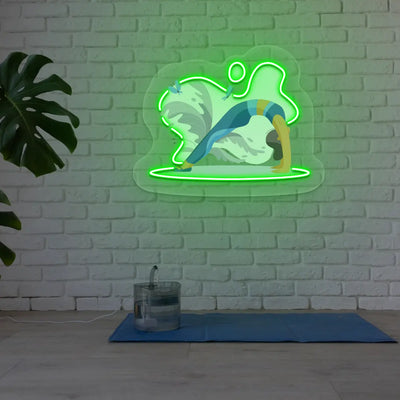 Urdhva Dhanurasana Yoga Neon Artwork lighting up in green color in a yoga room