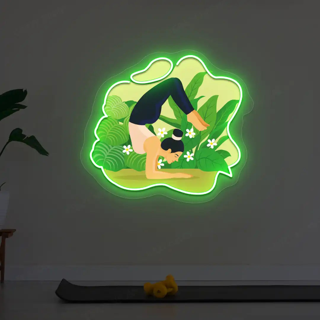 Vrischikasana Garden Yoga Neon Artwork lighting up in green color in a yoga room