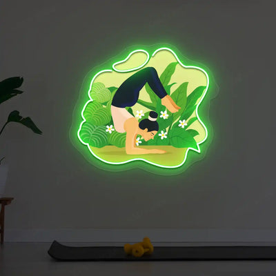 Vrischikasana Garden Yoga Neon Artwork lighting up in green color in a yoga room