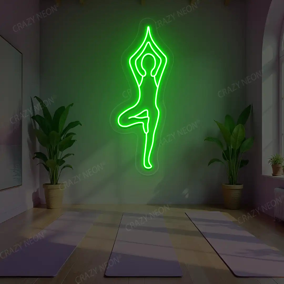 Vrikshasana Yoga Neon Sign lighting up in green color in a yoga room