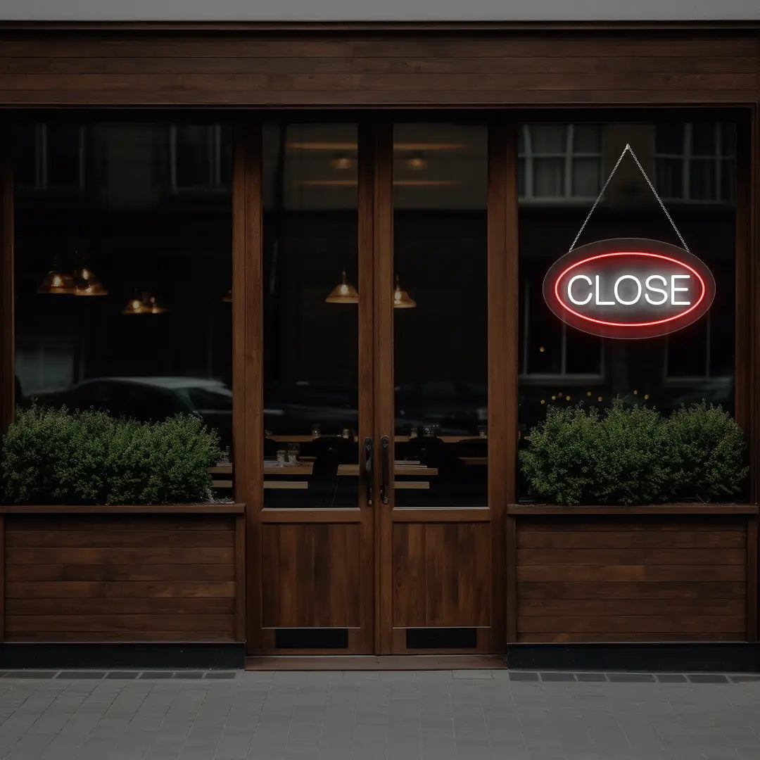 red oval close neon sign hanging on a window
