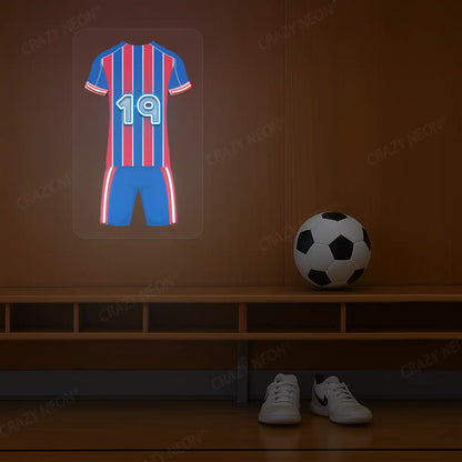 Red and blue striped football jersey neon artwork with number 19 glowing on a wooden wall