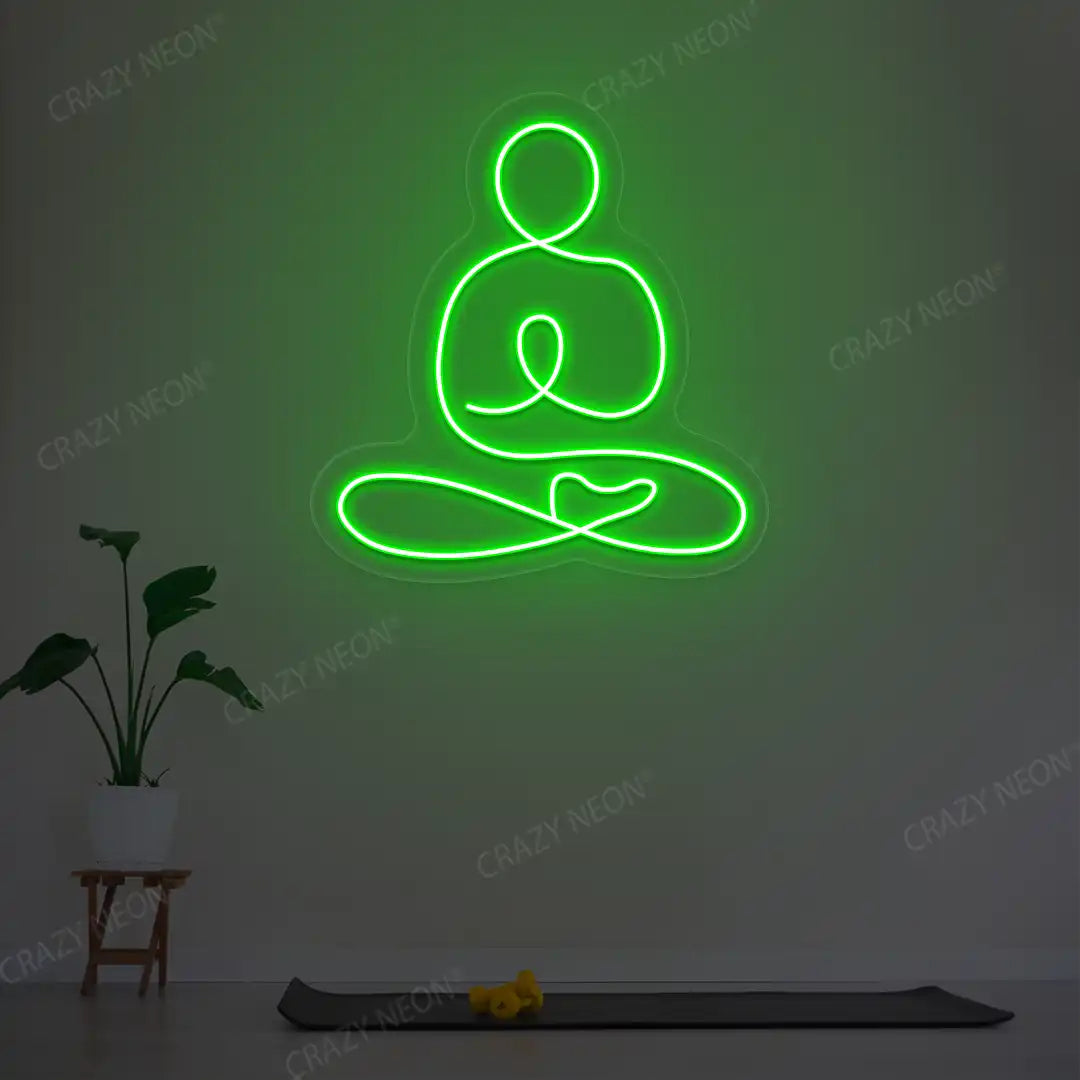 Swastikasana Yoga Neon Sign lighting up in green color in a yoga room