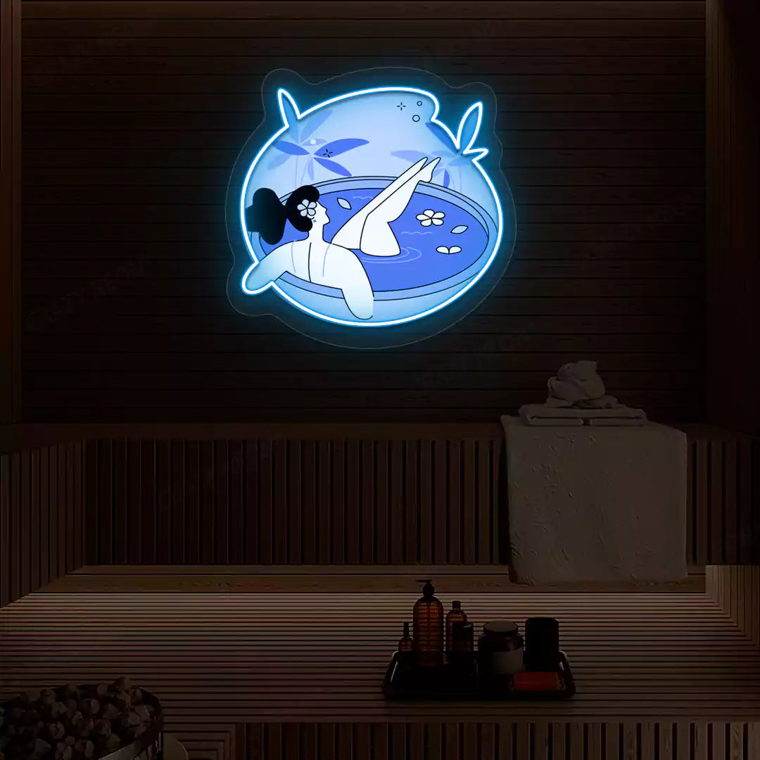 Blue Blossom Bath Neon Artwork lighting up in ice blue color on a wooden spa wall