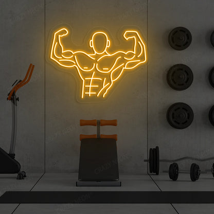 orange flexing bodybuilder gym neon sign mounted on a wall