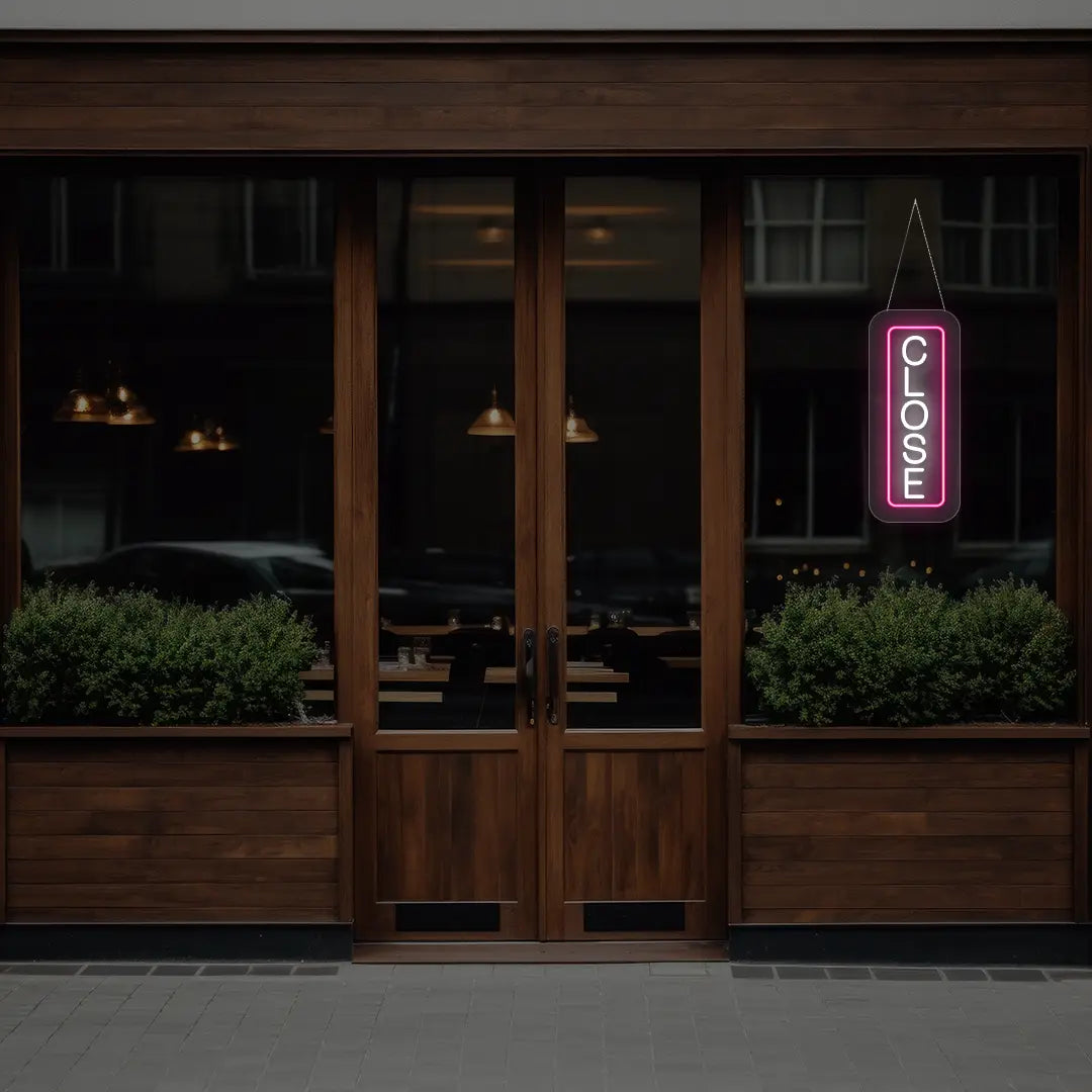 pink vertical close neon sign hanging on a window