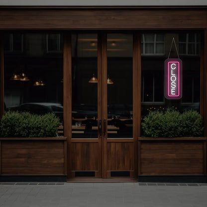 pink vertical close neon sign hanging on a window
