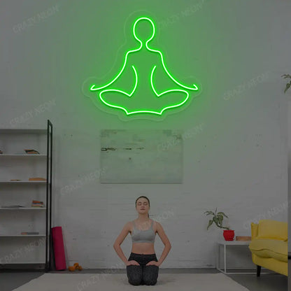 Sukhasana Yoga Neon Sign lighting up in green color in a yoga room