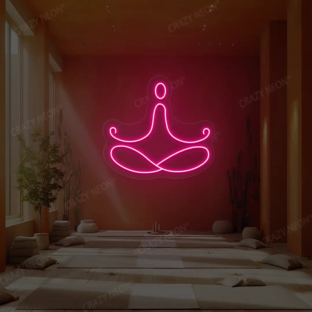 Padmasana Yoga Neon Sign lighting up in pink color in a yoga room
