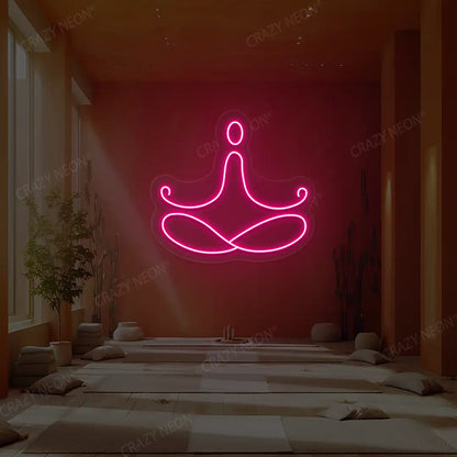 Padmasana Yoga Neon Sign lighting up in pink color in a yoga room