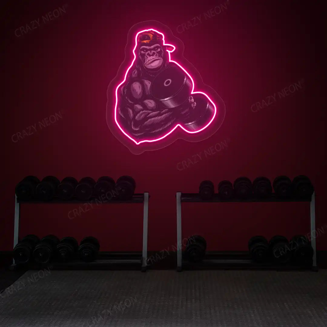 pink gorilla dumbbell lifting gym neon artwork mounted on a wall