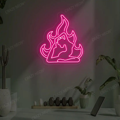 Flamed Eka Pada Rajakapotasana Yoga Neon Sign lighting up in pink color in a yoga room