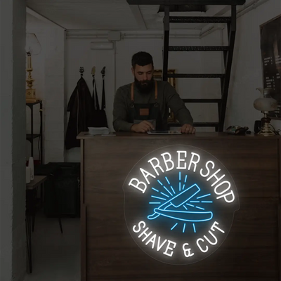 Barber Shop Shave & Cut Neon Sign in White and Ice Blue Colour mounted on wall