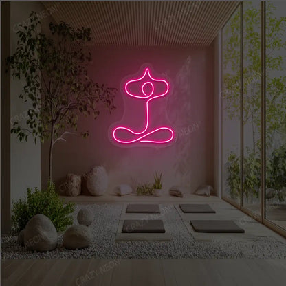Sukhasana With Arms Raised Contour Yoga Neon Sign glowing in pink color in a yoga room