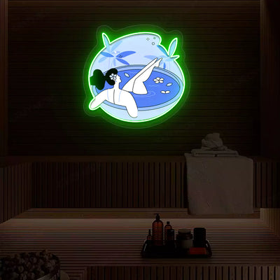 Blue Blossom Bath Neon Artwork lighting up in green color on a wooden spa wall