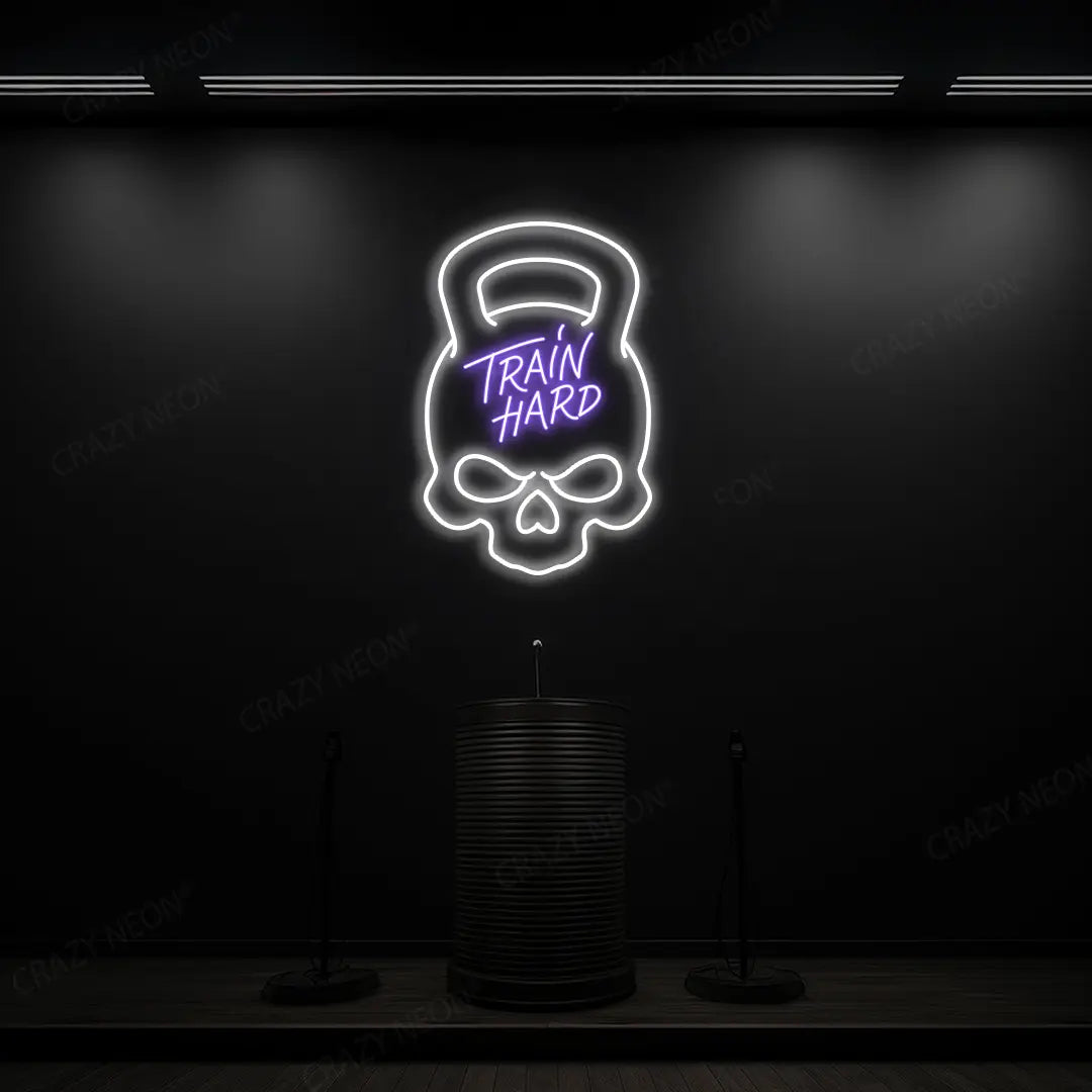 purple and white train hard kettlebell neon sign mounted on a wall