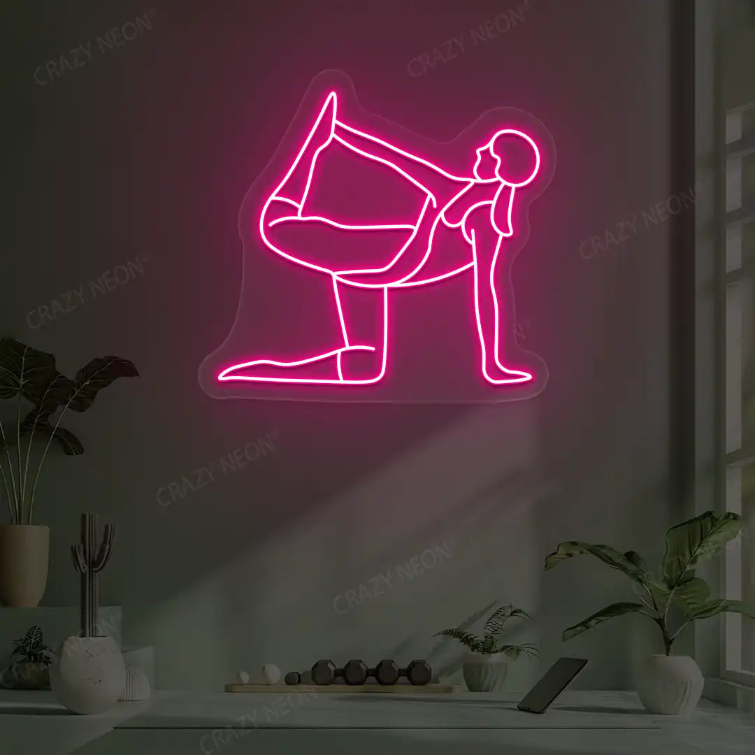 Ardha Dhanurasana Yoga Neon Sign glowing in pink color in a yoga room