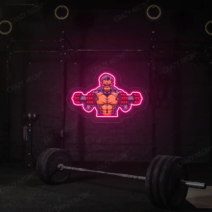 pink monkey workout gym neon artwork mounted on a wall