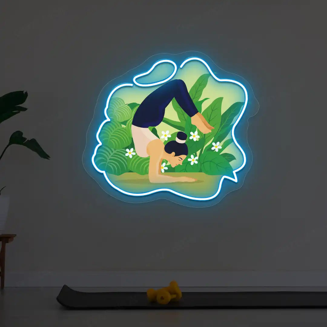 Vrischikasana Garden Yoga Neon Artwork lighting up in iceblue color in a yoga room