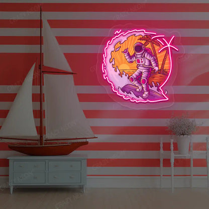 pink astronaut surfing neon artwork mounted on a wall