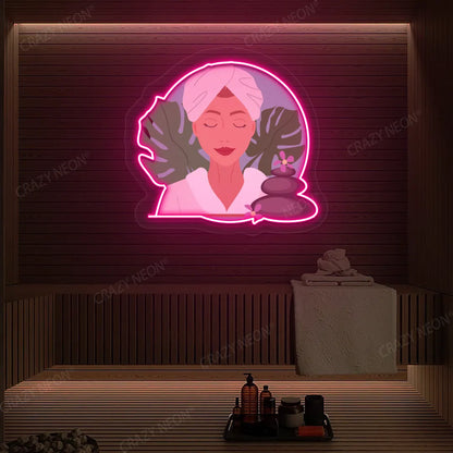 Zen Facial Spa Neon Artwork lighting up in pink color on a wooden spa wall
