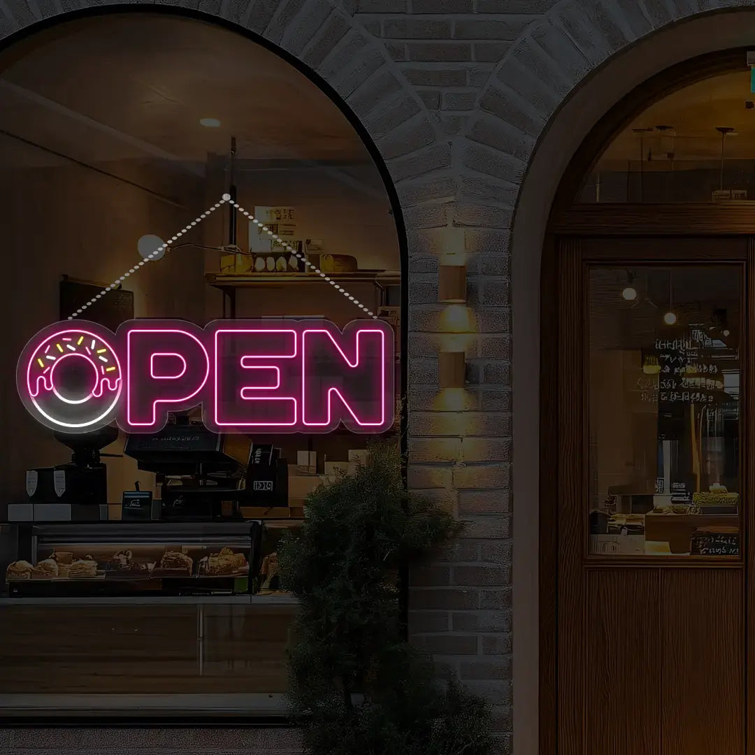 pink donut open neon sign hanging on a window