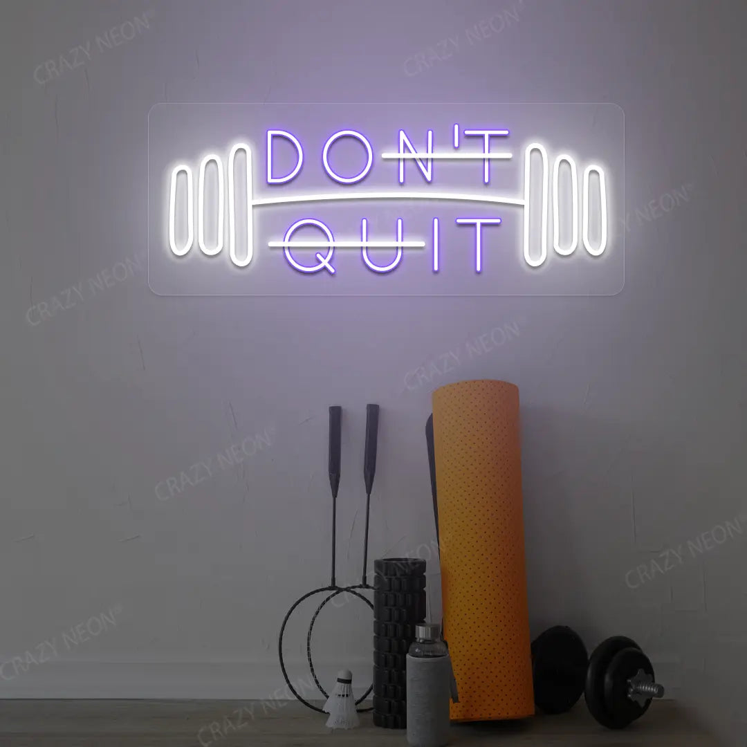 purple and white don’t quit do it neon sign mounted on a wall