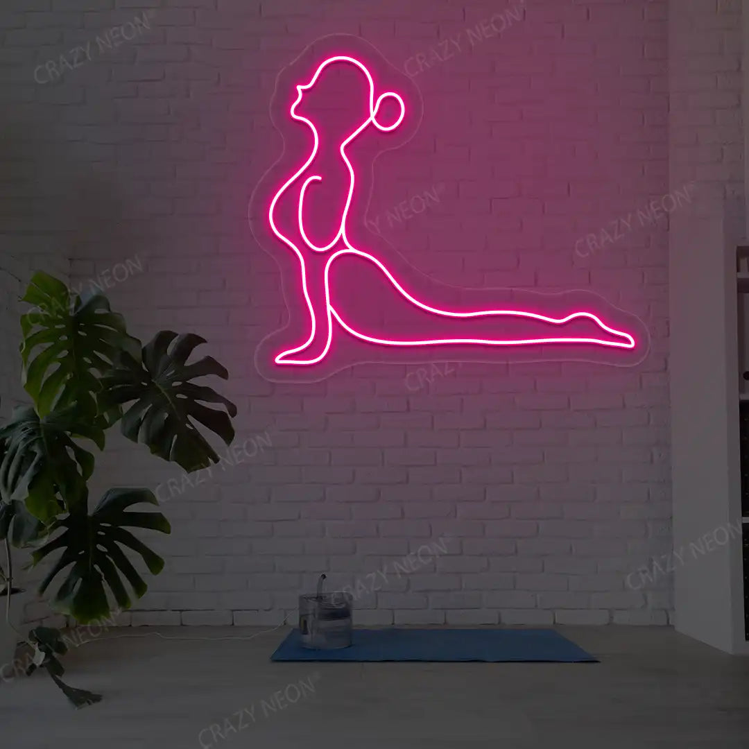 Bhujangasana Yoga Neon Sign glowing in pink color in a yoga room