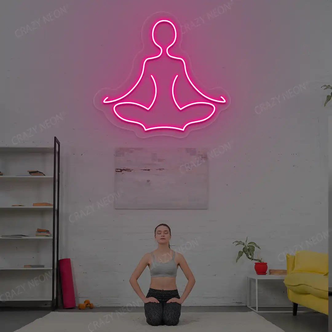 Sukhasana Yoga Neon Sign lighting up in pink color in a yoga room