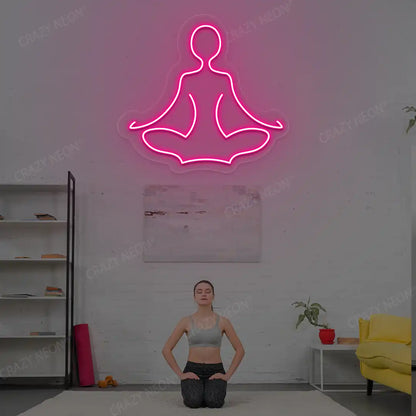 Sukhasana Yoga Neon Sign lighting up in pink color in a yoga room