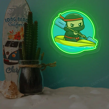 green ninja kayaking neon artwork mounted on a wall