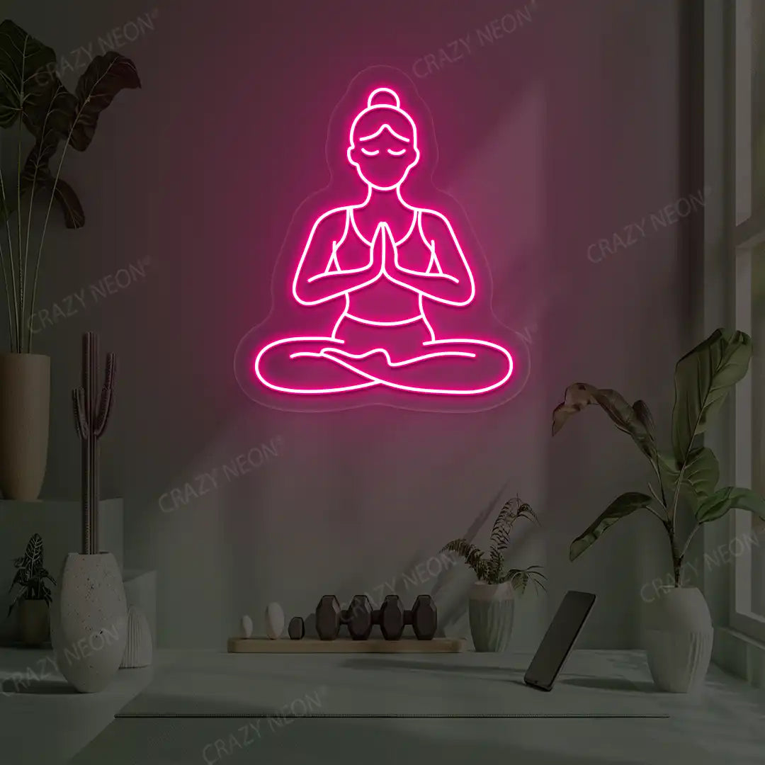 Padmasana Anjali Mudra Yoga Neon Sign lighting up in pink color in a yoga room