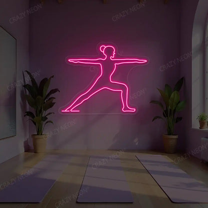 Virabhadrasana II Yoga Neon Sign lighting up in pink color in a yoga room