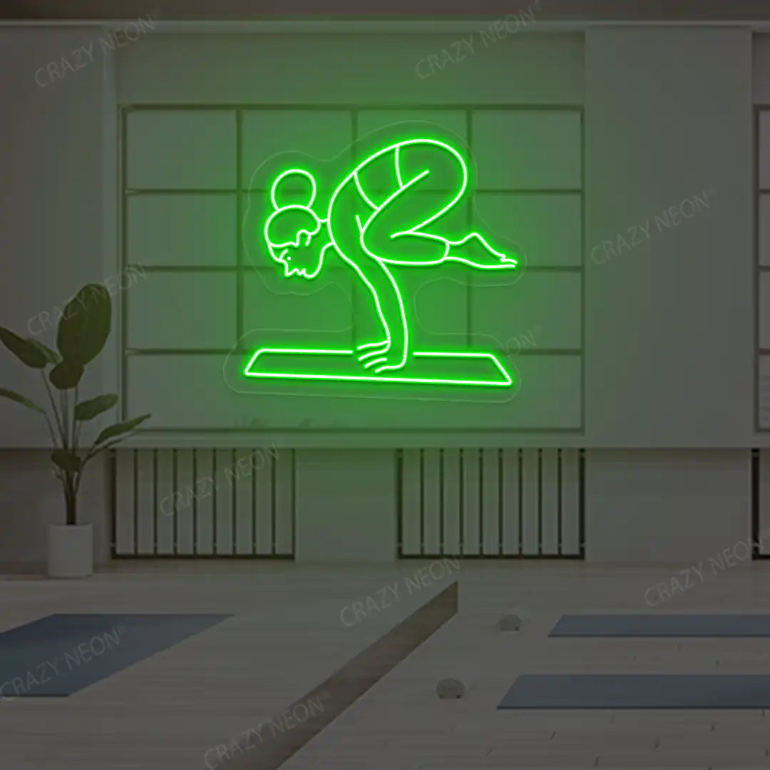 Bakasana Yoga Neon Sign lighting up in green color in a yoga room