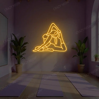 Eka Pada Rajakapotasana Yoga Neon Sign lighting up in orange color in a yoga room