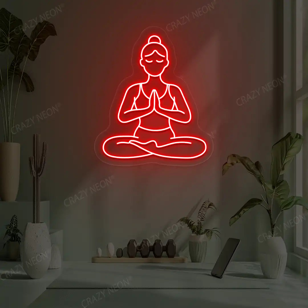 Padmasana Anjali Mudra Yoga Neon Sign lighting up in red color in a yoga room