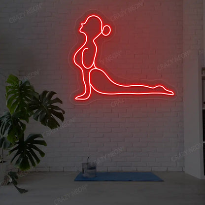 Bhujangasana Yoga Neon Sign glowing in red color in a yoga room