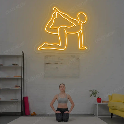 Eka Hasta Vyaghrasana Yoga Neon Sign glowing in orange color in a yoga room