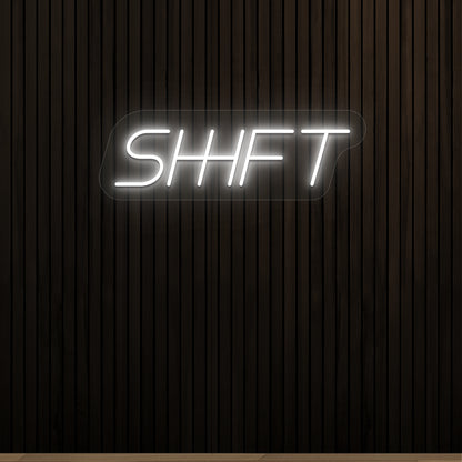 white shift vintage neon sign mounted on a wall