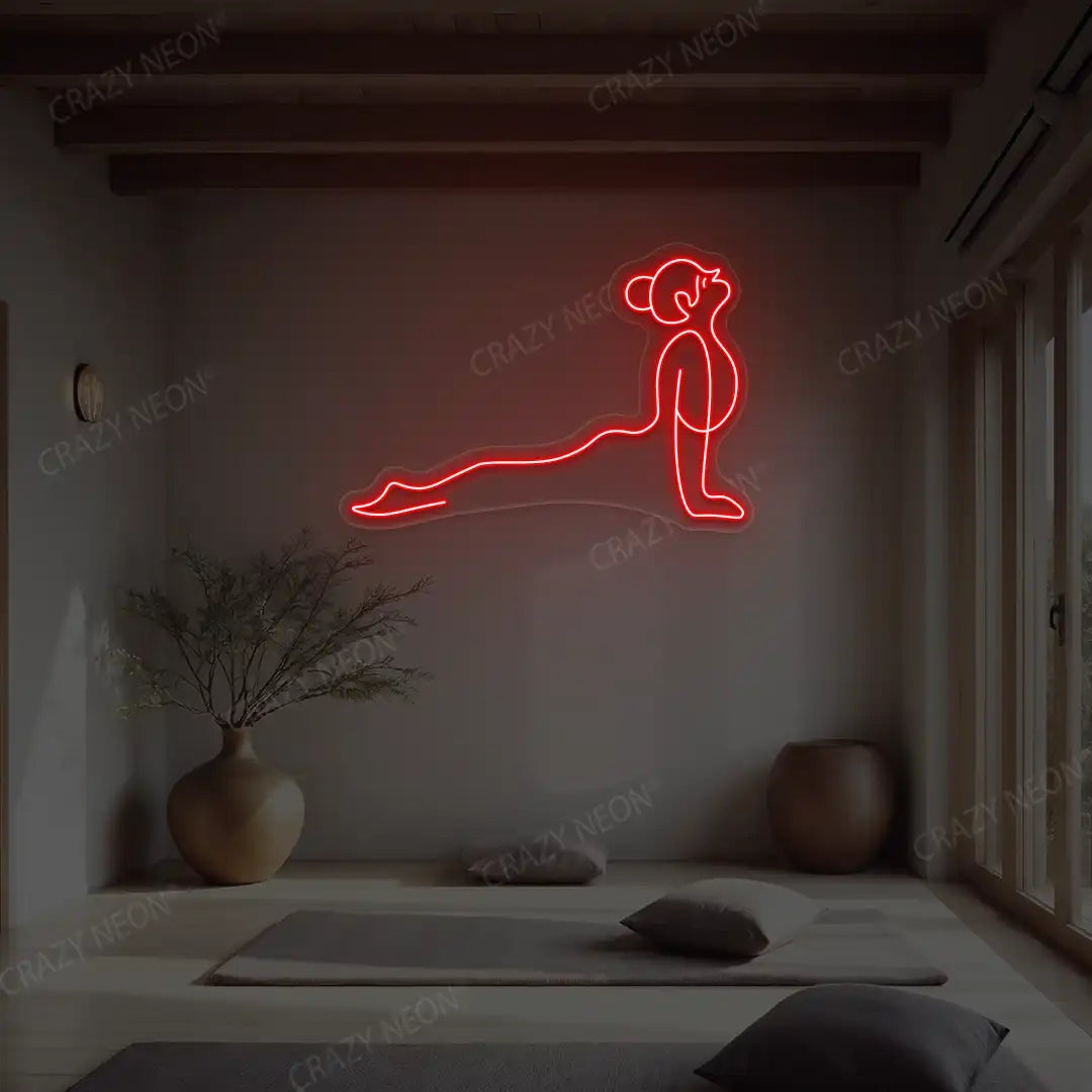 Urdhva Mukha Svanasana Yoga Neon Sign lighting up in red color in a yoga room