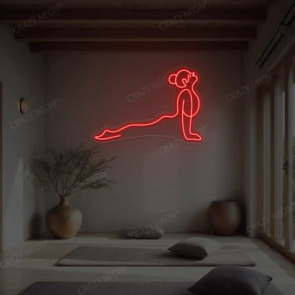 Urdhva Mukha Svanasana Yoga Neon Sign lighting up in red color in a yoga room