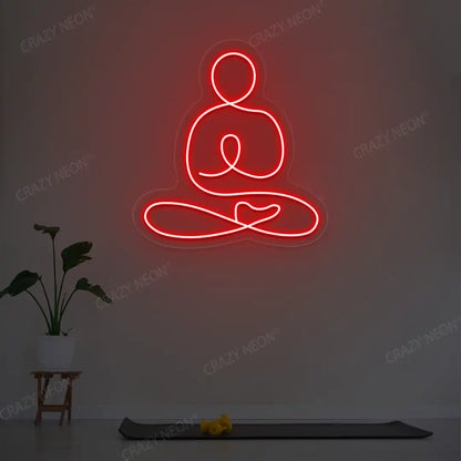 Swastikasana Yoga Neon Sign lighting up in red color in a yoga room